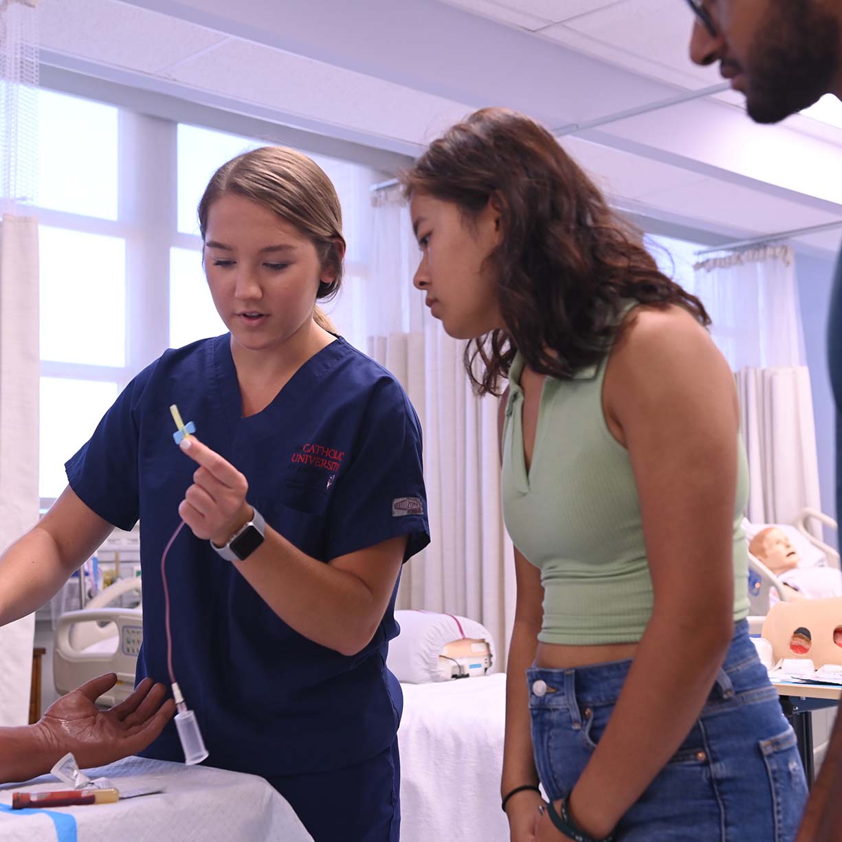 Nursing student showcasing how to insert an IV
