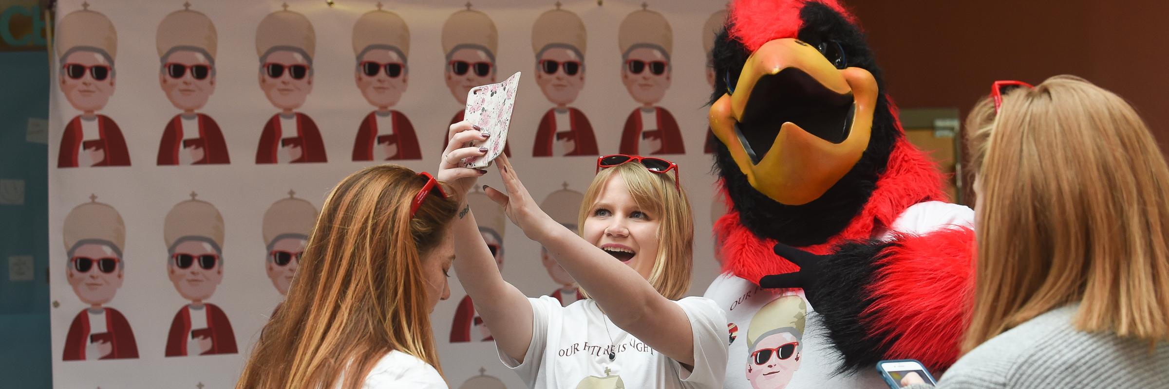 Students taking selfies with Red on Founders Day