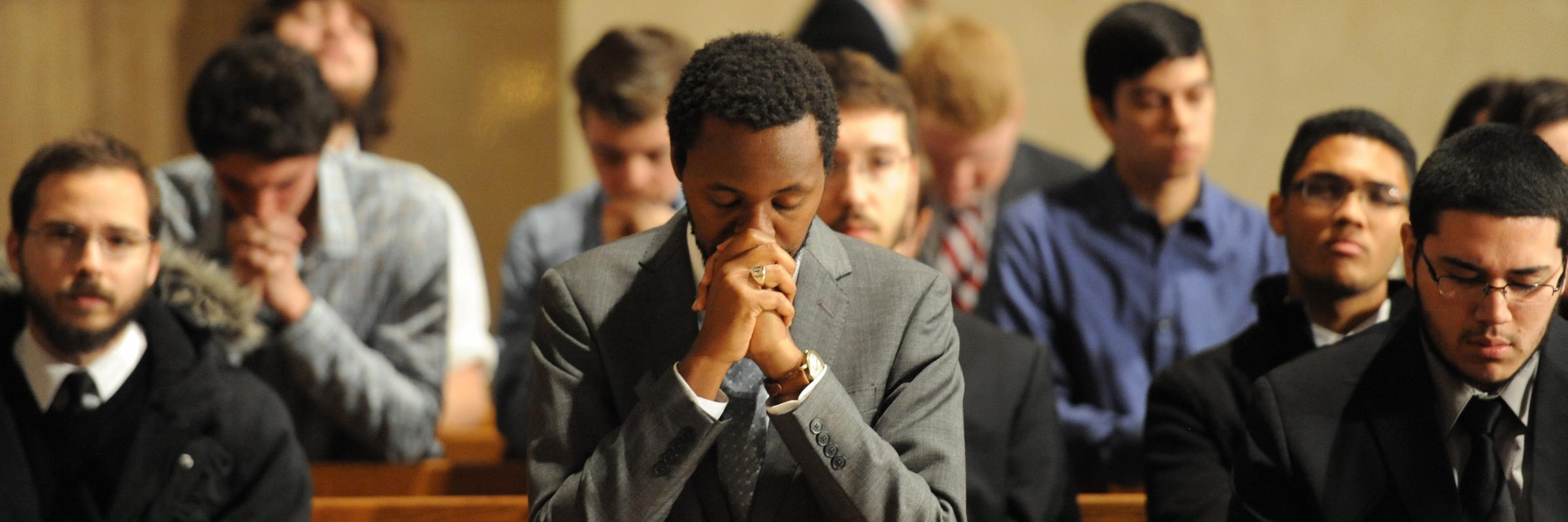 Students praying in the Caldwell Chapel