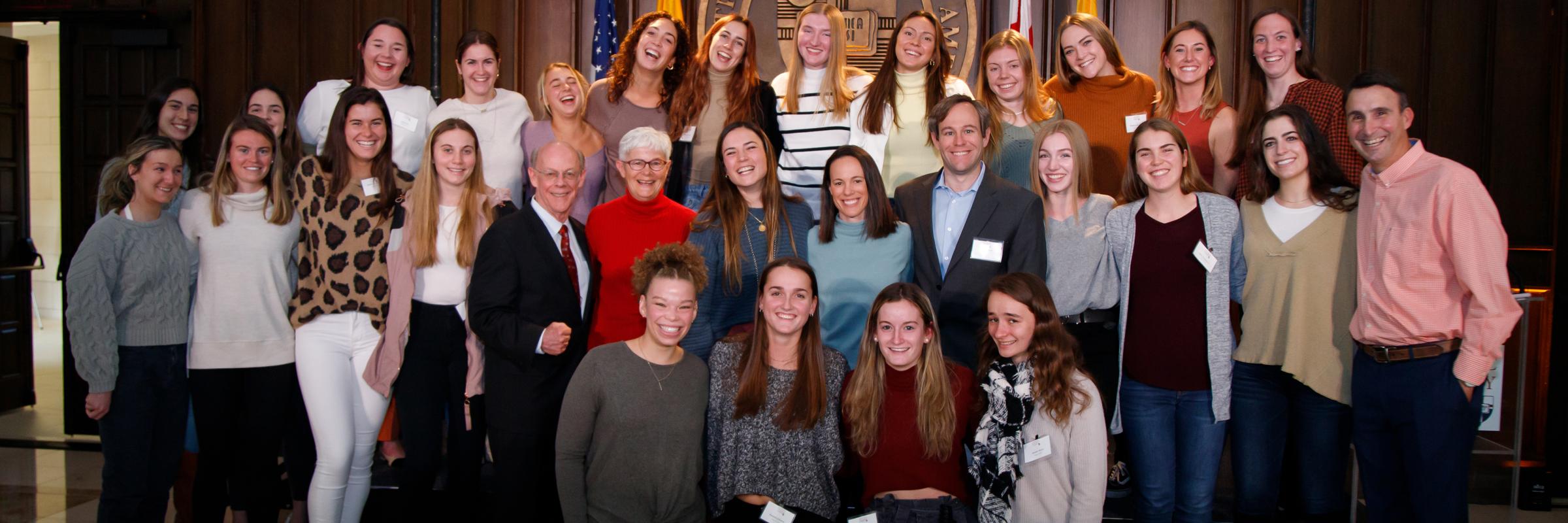 Bridget Power with the Roberts family and women's basketball team
