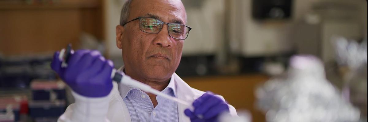 Dr. Venigalla Rao with a pipette