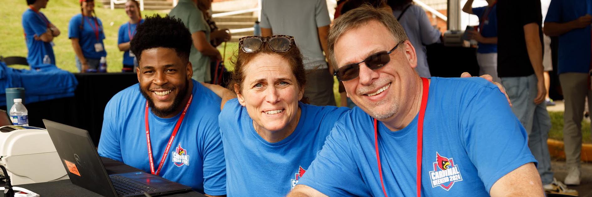 Staff at Cardinal Weekend table