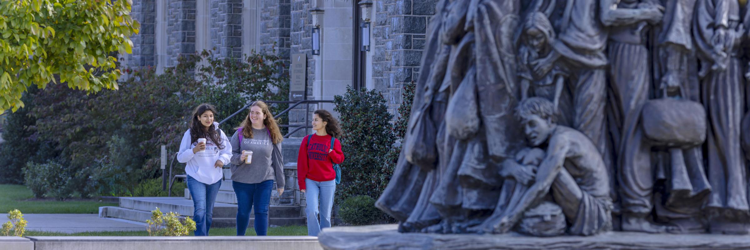 Students walking on campus behind Welcome Plaza - Angels Unawares