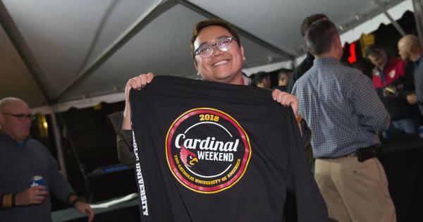 Student selling Cardinal Weekend merchandise