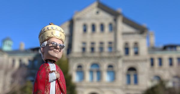 Bobblehead of Pope Leo XIII in front of McMahon Hall
