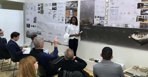 An architecture student talks with colleagues