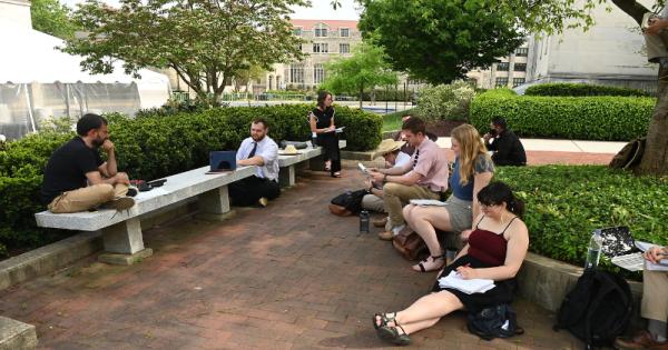 Group of Philosophy students taking class outdoors