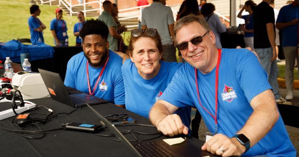 Staff at CArdinal Weekend table