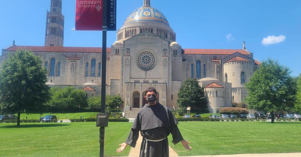 Franciscan friar in front of the Basilica