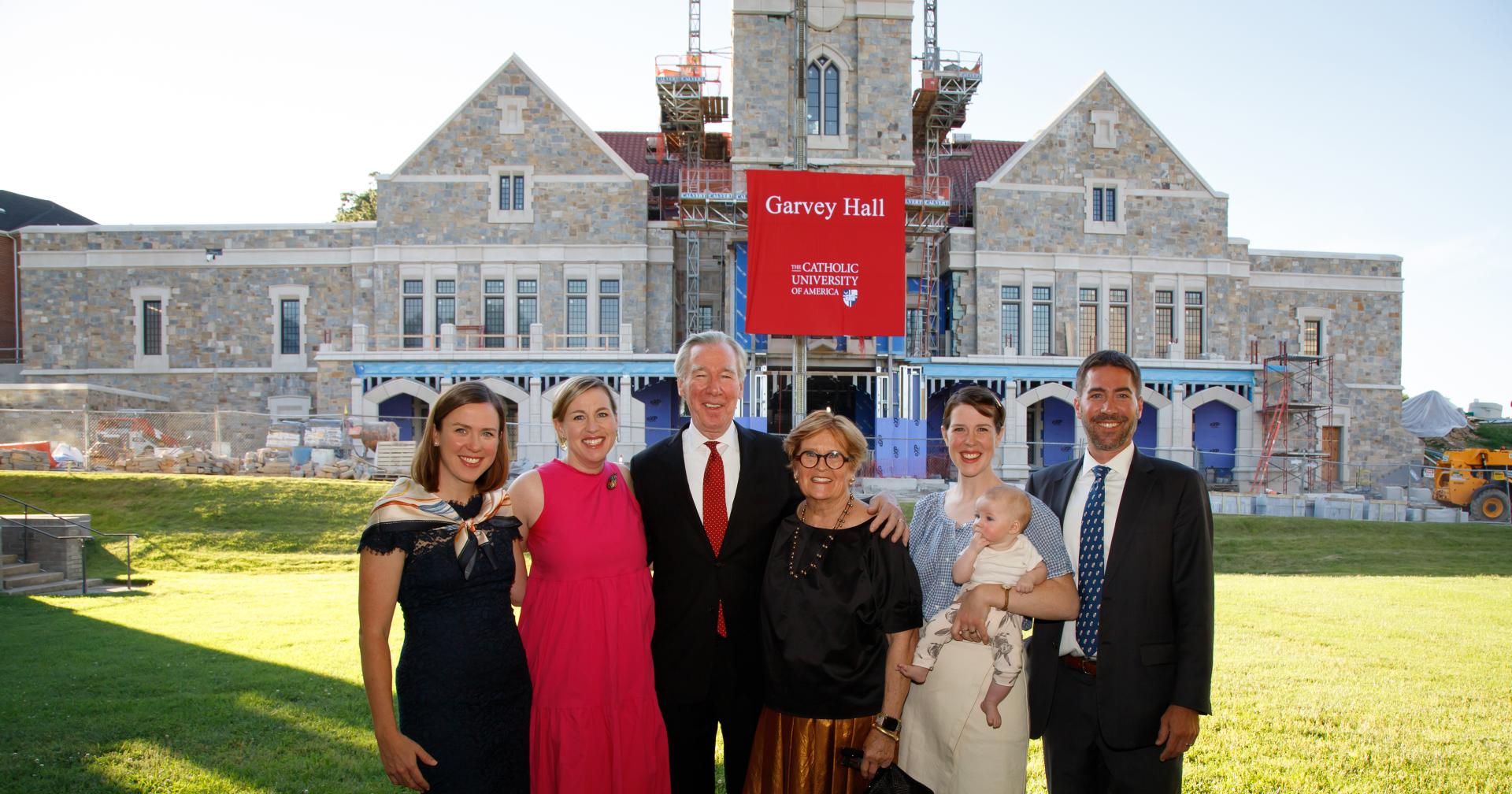 John and Jeanne Garvey with family members in front of Garvey Hall