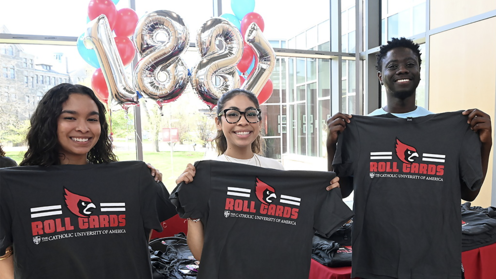 Students holding Founders Day 2024 T-shirts