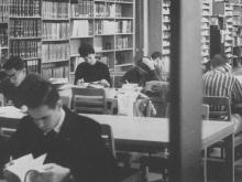 Archival photo of people studying in Mullen Library