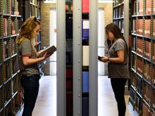 Students in the Mullen Library stacks